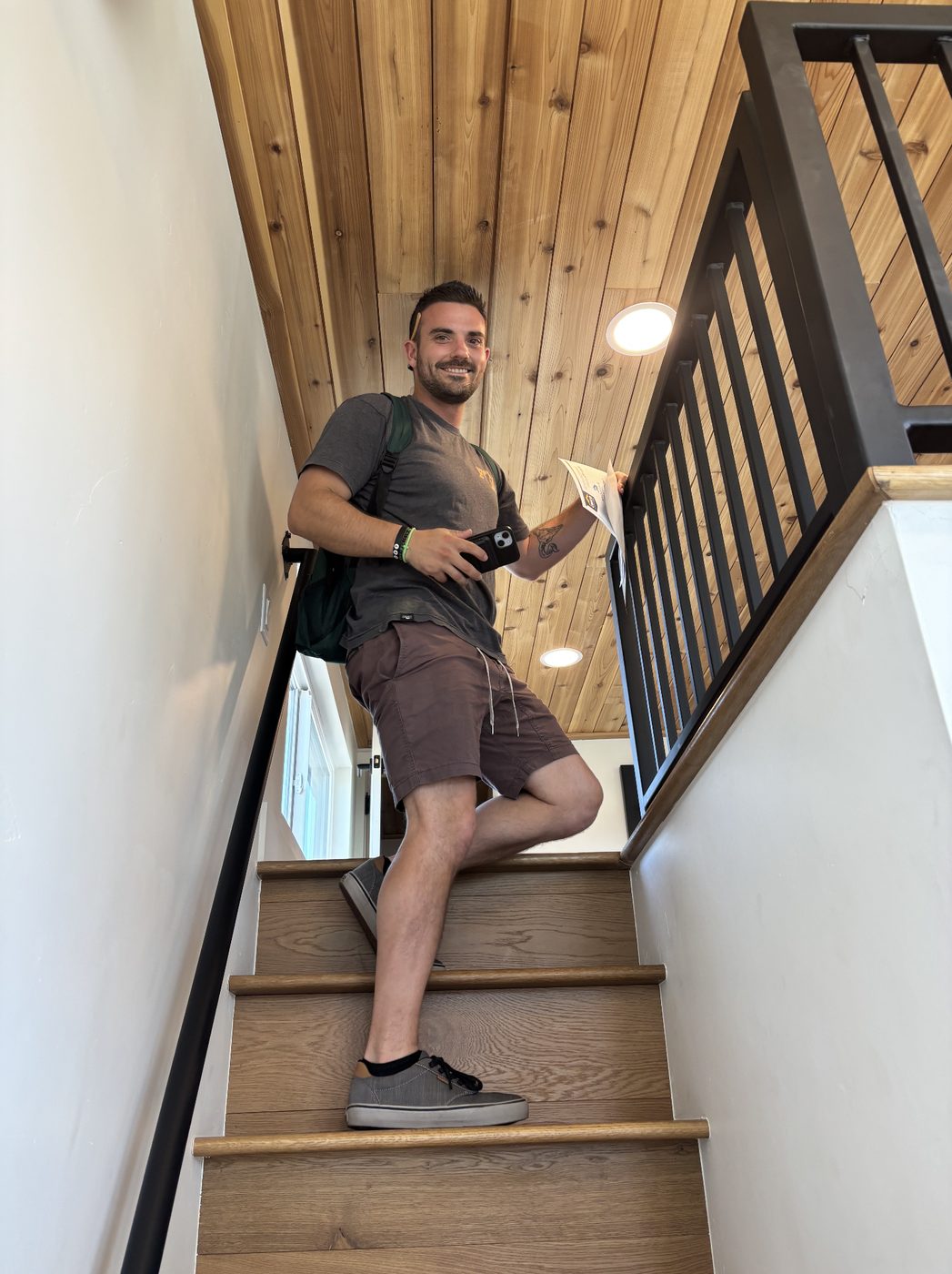 Trent walking up the stairs to a tiny home loft